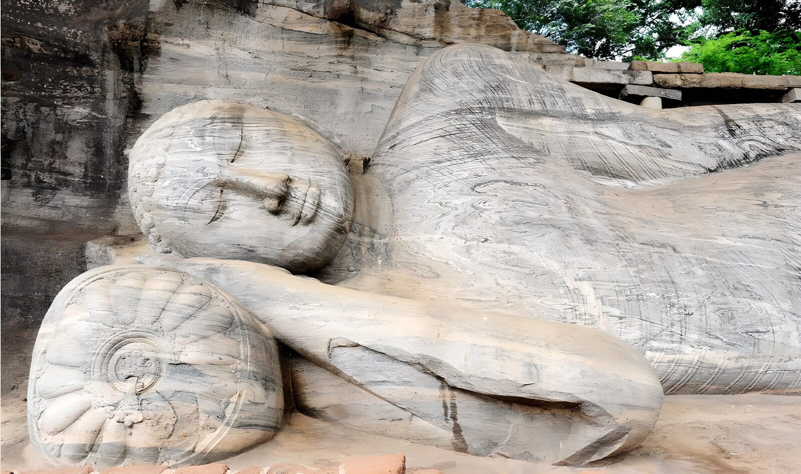 HPDK75485: Liggende Buddha i lys, vejrbidt sten